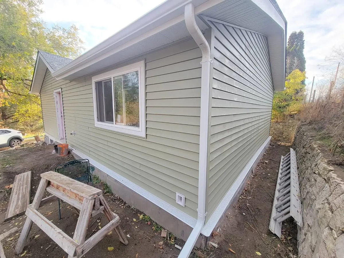 Completed Hunter Exteriors siding job, gable end with new gutters